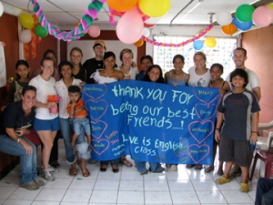 at the chureca party with the homemade sign that reads "thank you for being our best friends!"